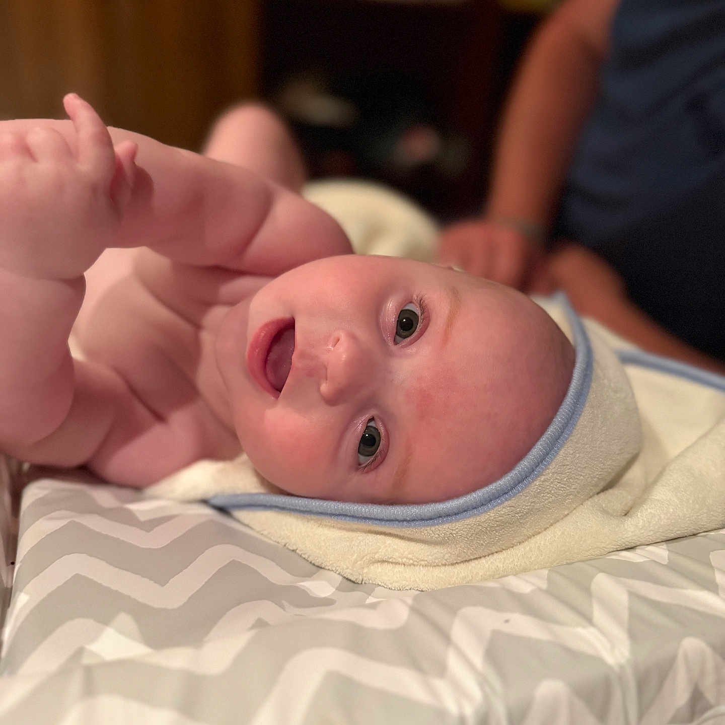 Oliver joined the competition — help win amazing prizes! adult, baby, blurred_background, changing_pad, chubby, curious, cute, expression, eyes, face, hand, head, indoor, infant, lying_down, pattern, person, skin, soft_lighting, towel