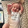 Oliver joined the competition — help win amazing prizes! baby, onesie, smiling, infant, happy, child, lying_down, reaching_hand, changing_mat, patterned, text_on_clothing, indoor, cute, skin, hand, foot, fabric, soft_toys, baby_wipes, parenting
