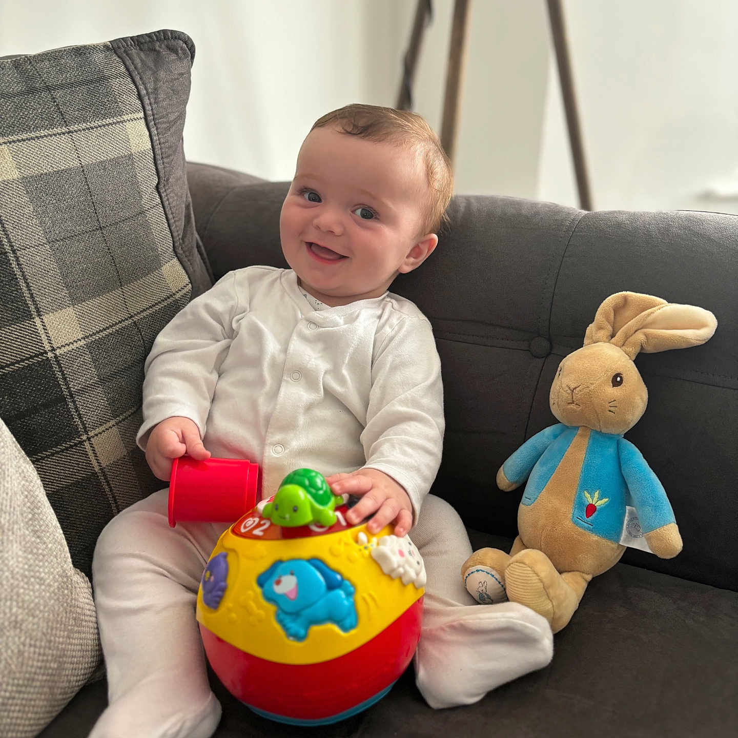 Tommy joined the competition — help win amazing prizes! architecture, baby, bodypart, building, couch, cushion, face, finger, furniture, hand, head, homedecor, indoors, person, photography, plush, portrait, sitting, sphere, toy