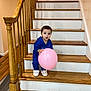 toddler, balloon, stairs, wooden_stairs, blue_outfit, slippers, indoor, handrail, wooden_floor, child, curious, pink_balloon, home_interior, person, smiling, standing, railing, footwear, young_child, face