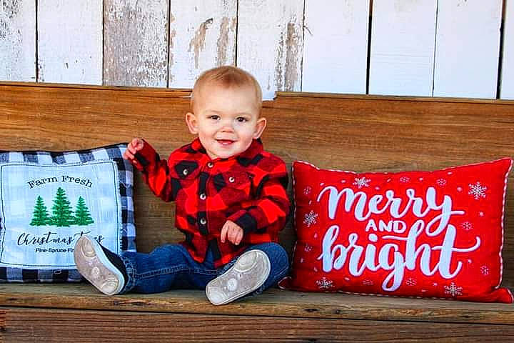 Boston is registered to the contest to win money with this photo: baby, baby_laughing, baby_toddler_clothing, child, eye, joy, laugh, living_room, mouth, nose, person, shoe, sitting, throw_pillow, toddler