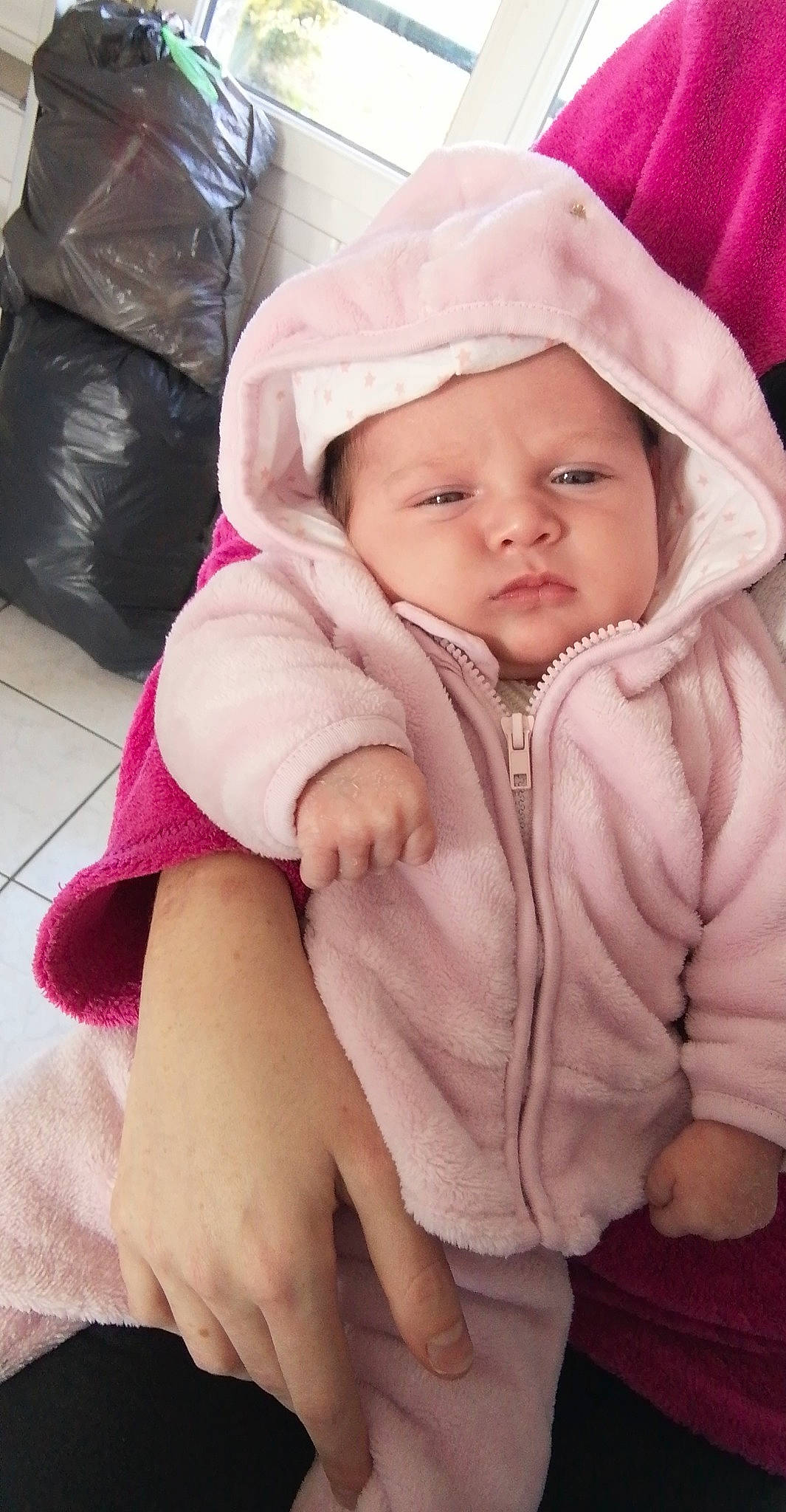 Rose participe au concours pour gagner de l'argent avec cette photo : baby, baby_toddler_clothing, cap, cheek, chin, comfort, eye, head, headgear, headwear, jacket, lip, luggage_and_bags, nose, person, photograph, pink, skin, sleeve, textile