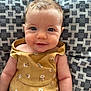Constance participe au concours pour gagner de l'argent avec cette photo : baby, smile, face, eyes, dress, yellow, pattern, cushion, fabric, child, infant, cute, skin, arm, person, indoors, portrait, happy, young, sitting