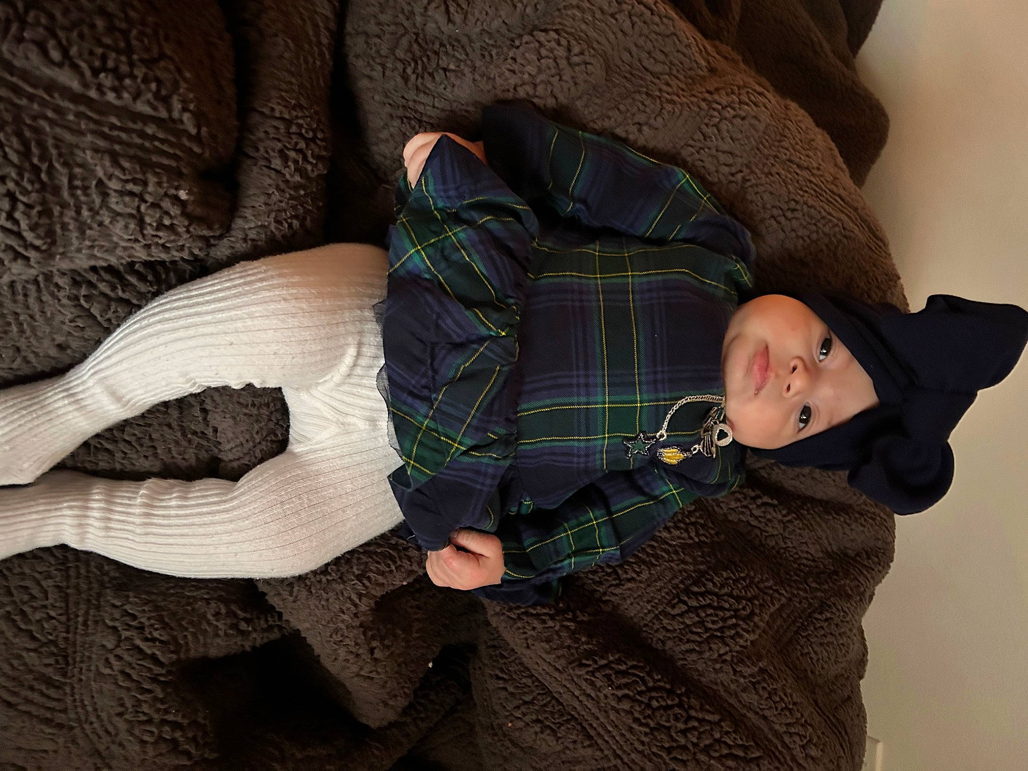 Iliana Jesil is registered to the contest to win money with this photo: baby, baby_toddler_clothing, child, comfort, couch, hand, headwear, human_body, human_leg, lap, leg, linens, pattern, person, plaid, sitting, sleeve, tartan, textile, toddler