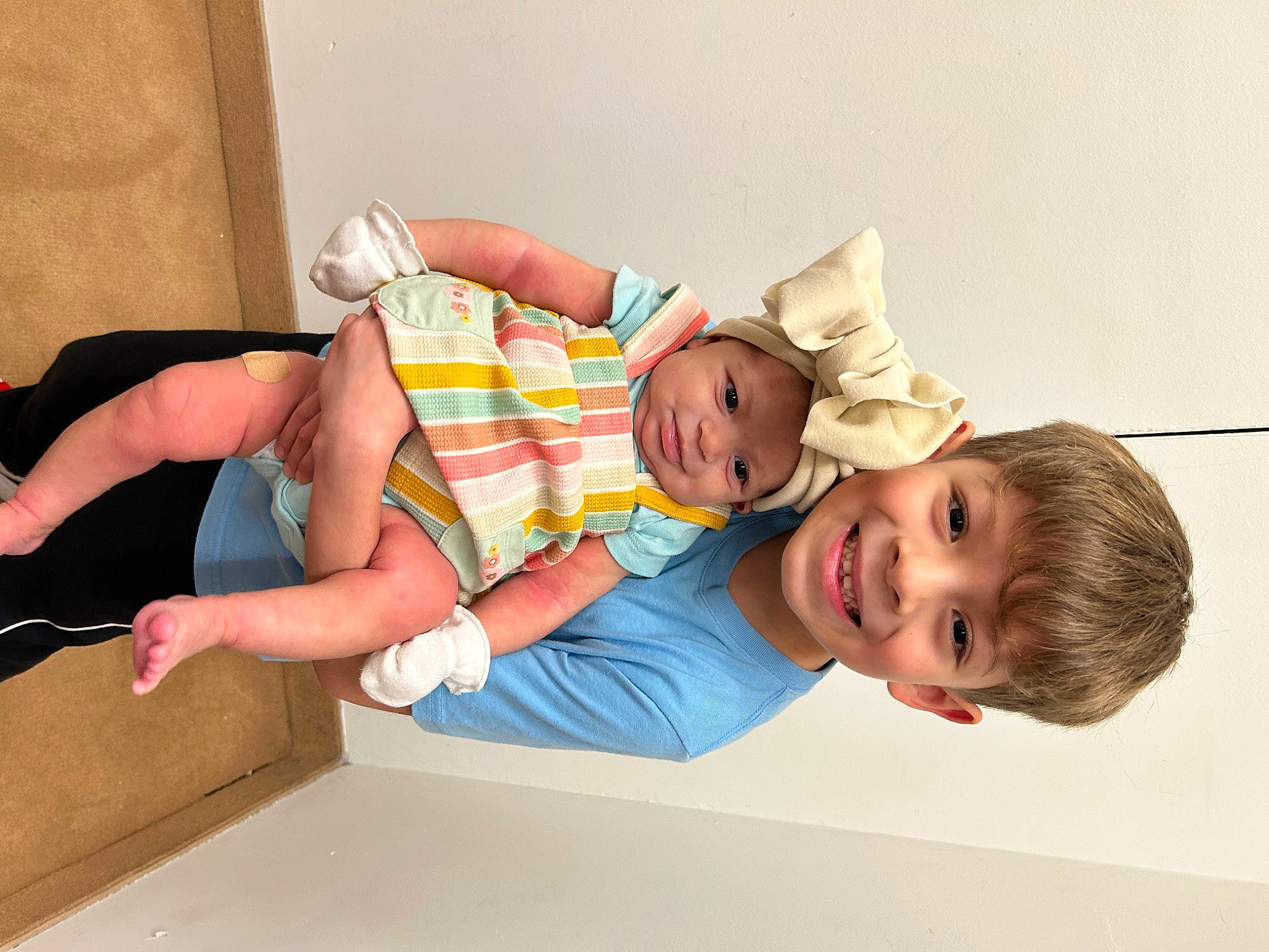 Julian Hernan is registered to the contest to win money with this photo: baby, baby_laughing, baby_toddler_clothing, child, comfort, elbow, foot, fun, happy, hat, headwear, human_leg, joy, knee, leisure, person, room, smile, sock, t_shirt