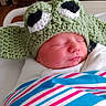Daniel is registered to the contest to win money with this photo: newborn, baby, sleeping, crocheted_hat, green_hat, hospital_blanket, wrapped, bassinet, cute, infant, face, peaceful, indoors, portrait, soft_light, pink_skin, child, headwear, closeup, resting