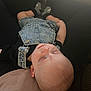 baby, sleeping, denim_overalls, black_shirt, couch, indoors, peaceful, child, infant, soft_light, portrait, head, face, closed_eyes, relaxing, casual_clothing, small_footwear, human, resting, cute