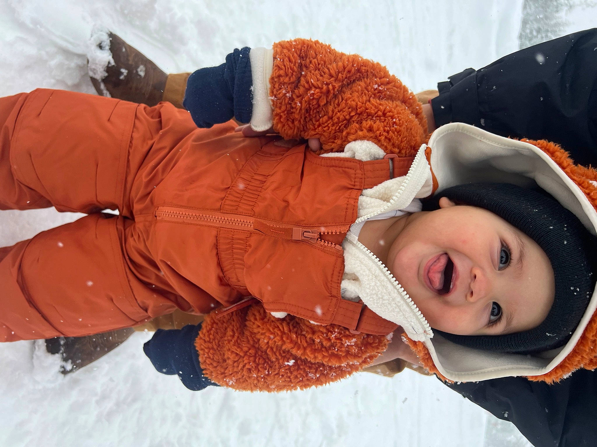 Mathias is registered to the contest to win money with this photo: child, comfort, freezing, fun, fur, glove, happy, headgear, headwear, jacket, leisure, outerwear, person, playing_in_the_snow, recreation, sitting, smile, snow, toddler, tree