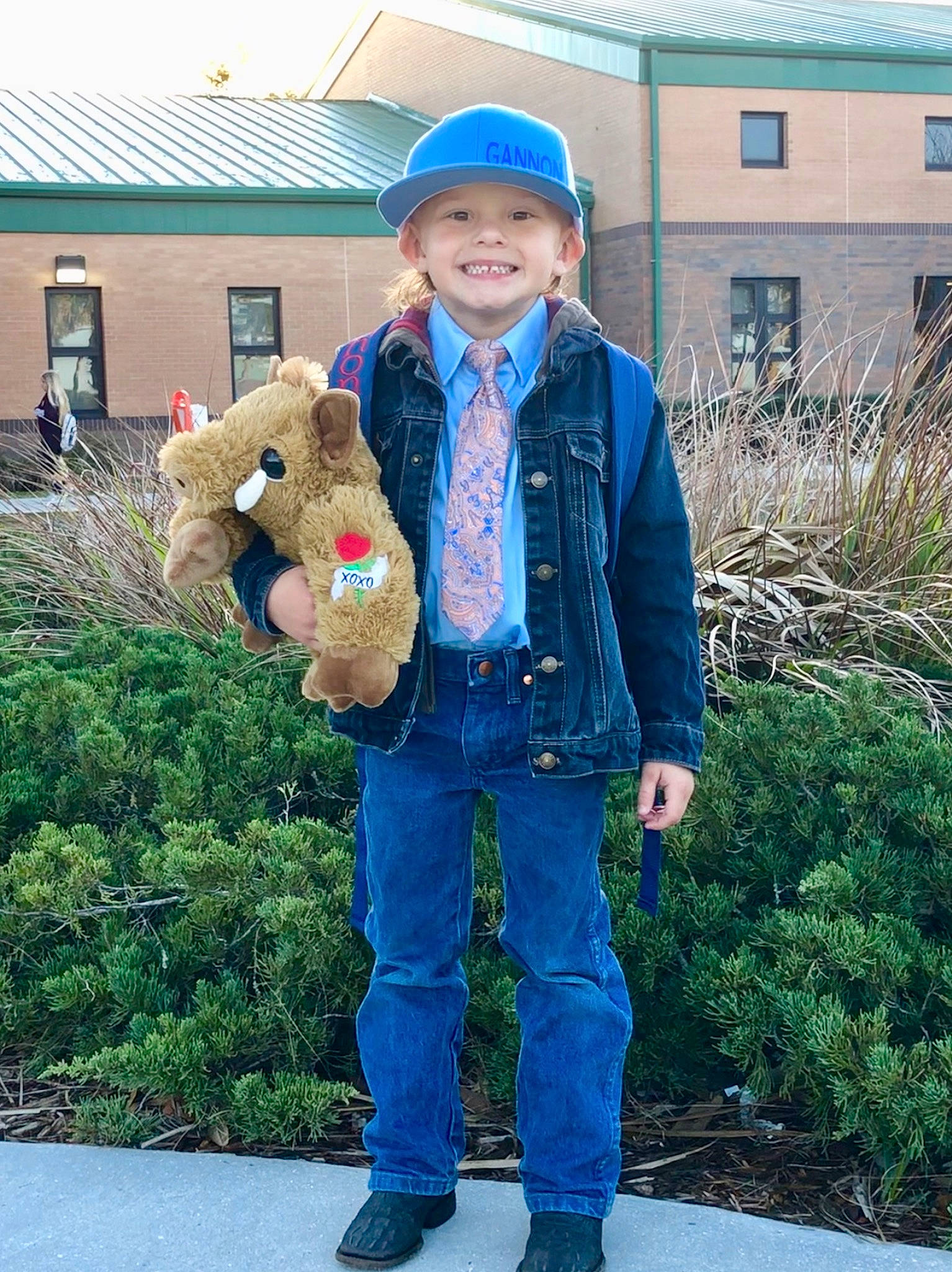 Gannon is registered to the contest to win money with this photo: child, denim, fur, headgear, headwear, jacket, jeans, joy, outerwear, person, standing