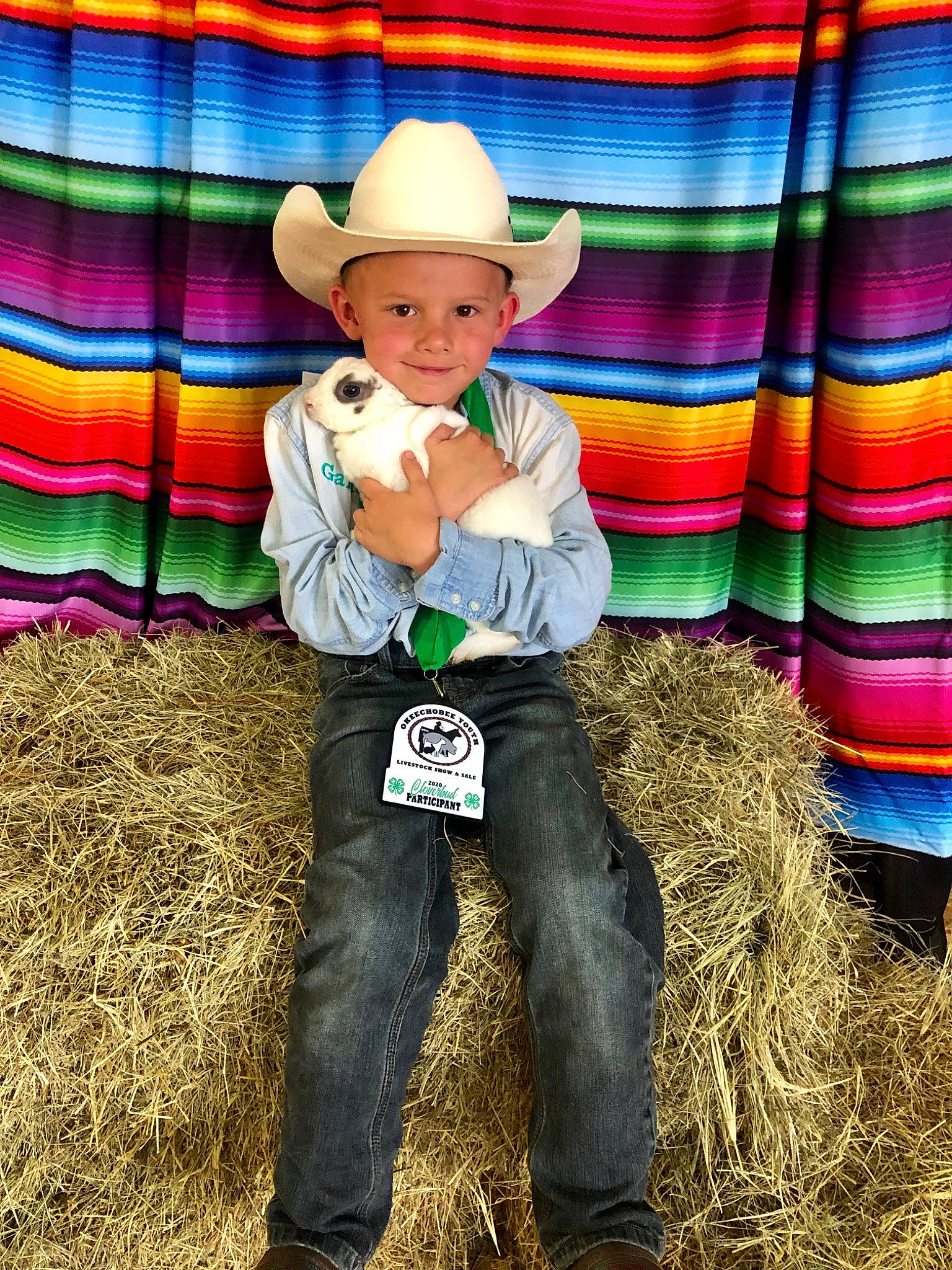 Gannon is registered to the contest to win money with this photo: child, cowboy_hat, fashion_accessory, fun, grass, hat, headgear, headwear, joy, person, plant, smile, sombrero, toddler