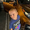 Abal is registered to the contest to win money with this photo: asphalt, boy, car, casual_clothing, child, colorful, head, looking_away, nasa_logo, night, open_car_door, outdoor, parking_lot, person, reflection, shoes, short_hair, standing, tshirt, vehicle