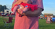 Leann Marie joined the competition — help win amazing prizes! baby, cap, casual_clothing, child, daylight, event, family, grass, holding, man, nature, outdoor, park, people, recreation, red_dress, relaxation, shorts, sky, summer