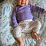 Ava joined the competition — help win amazing prizes! baby, infant, smile, purple_shirt, printed_pants, pillow, leaf_pattern, blanket, carpet, laying_down, toes, chubby_cheeks, newborn, portrait, indoor, cute, happy, clothing, soft_texture, relaxed