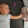 Ava joined the competition — help win amazing prizes! baby, infant, onesie, plush_toy, stuffed_bunny, pacifier, sofa, couch, blanket, hand, arm, face, side_profile, knit, fabric, texture, looking, home, soft, cute