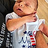Gavin joined the competition — help win amazing prizes! newborn, baby, infant, sleeping, person, arm, clothing, onesie, indoor, wood_floor, hand, holding, peaceful, cute, toddler, adult, skin, portrait, human, resting