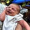arm, baby, blue, canopy, closeup, daylight, expression, hand, happy, head, infant, nature, newborn, outdoor, parent, person, portrait, skin, smile, white_clothing