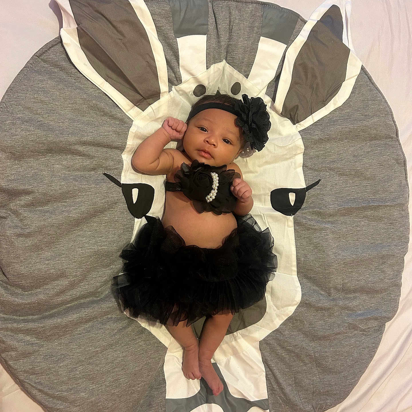 Julianna is registered to the contest to win money with this photo: baby, bed, bedroom, bodypart, clothing, costume, couch, cushion, dress, face, finger, formalwear, furniture, hand, head, homedecor, indoors, person, photography, portrait