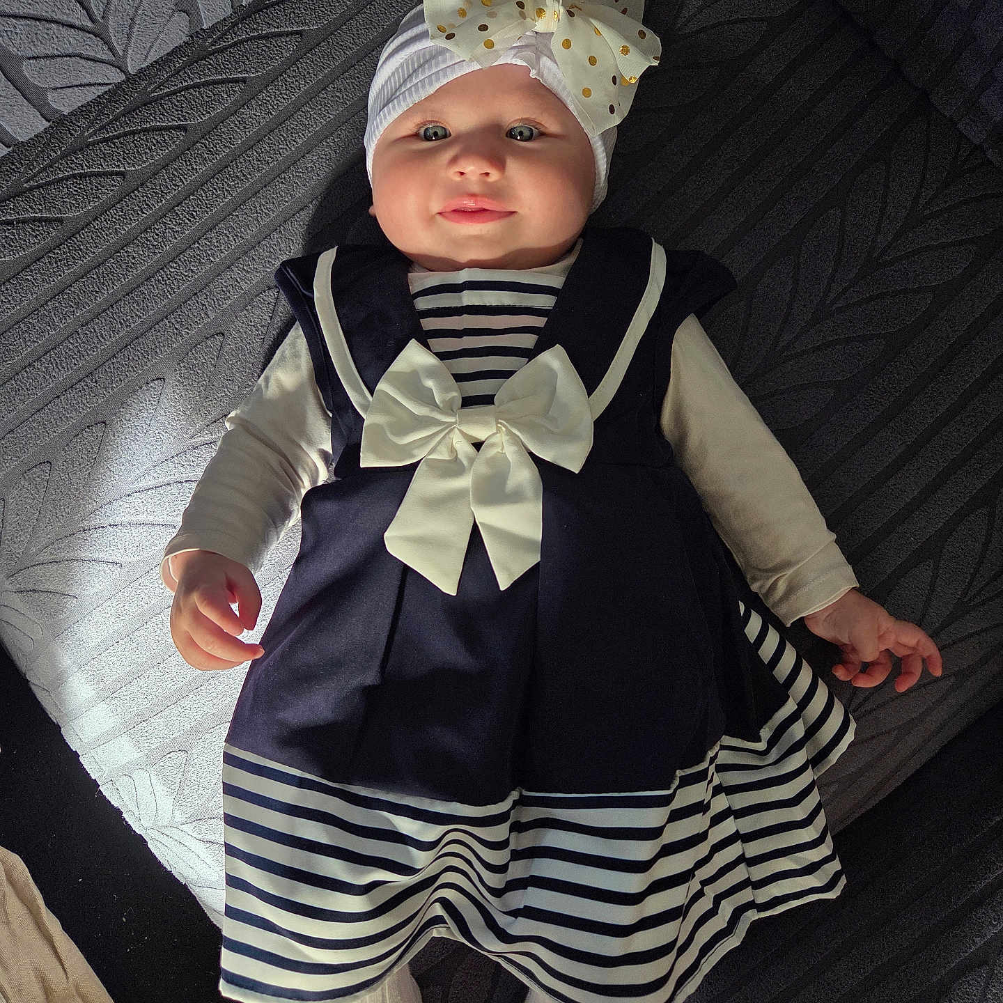Romy a rejoint le concours — aidez-le/la à gagner de superbes lots ! baby, child, infant, dress, bow, headband, striped_clothing, navy_blue, white, lying_down, soft_light, texture, fabric, cute, adorable, portrait, indoor, person, smile, happy
