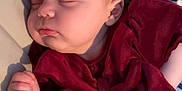 Amelia joined the competition — help win amazing prizes! baby, sleeping, infant, maroon_clothing, bow, blanket, striped_blanket, floral_blanket, peaceful, face, hand, soft_lighting, indoors, cozy, cute, child, portrait, resting, small_hands, newborn
