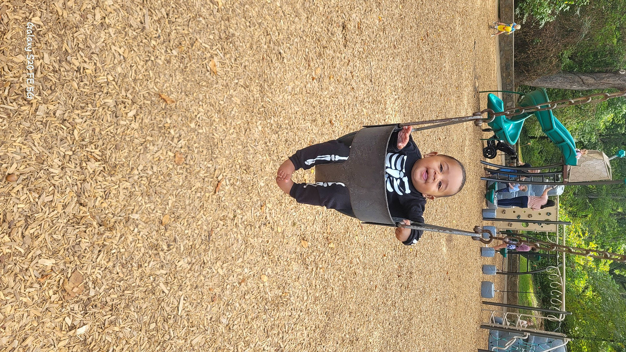 Azriel is registered to the contest to win money with this photo: child, city, fun, grass, landscape, leisure, outdoor_play_equipment, people_in_nature, person, plant, recreation, shadow, smile, soil, toddler, tree