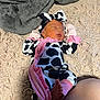 newborn, baby, sleeping, cow_print, onesie, headband, pink, black_and_white, feet, carpet, blanket, soft_texture, infant, child, cute, cozy, indoor, person, resting, clothing
