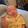 Kane joined the competition — help win amazing prizes! baby, bookshelf, casual_clothing, child, cozy, cushion, cute, dvd_collection, home, indoor, infant, person, plush_toy, portrait, relaxed, sitting, smiling, tongue_out, window, yellow_shirt