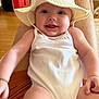 Alba a rejoint le concours — aidez-le/la à gagner de superbes lots ! baby, baby_face, child, closeup, cute, expression, floor, happy, hat, home, indoor, infant, legs, onesie, person, portrait, sitting, skin, smiling, white_clothing