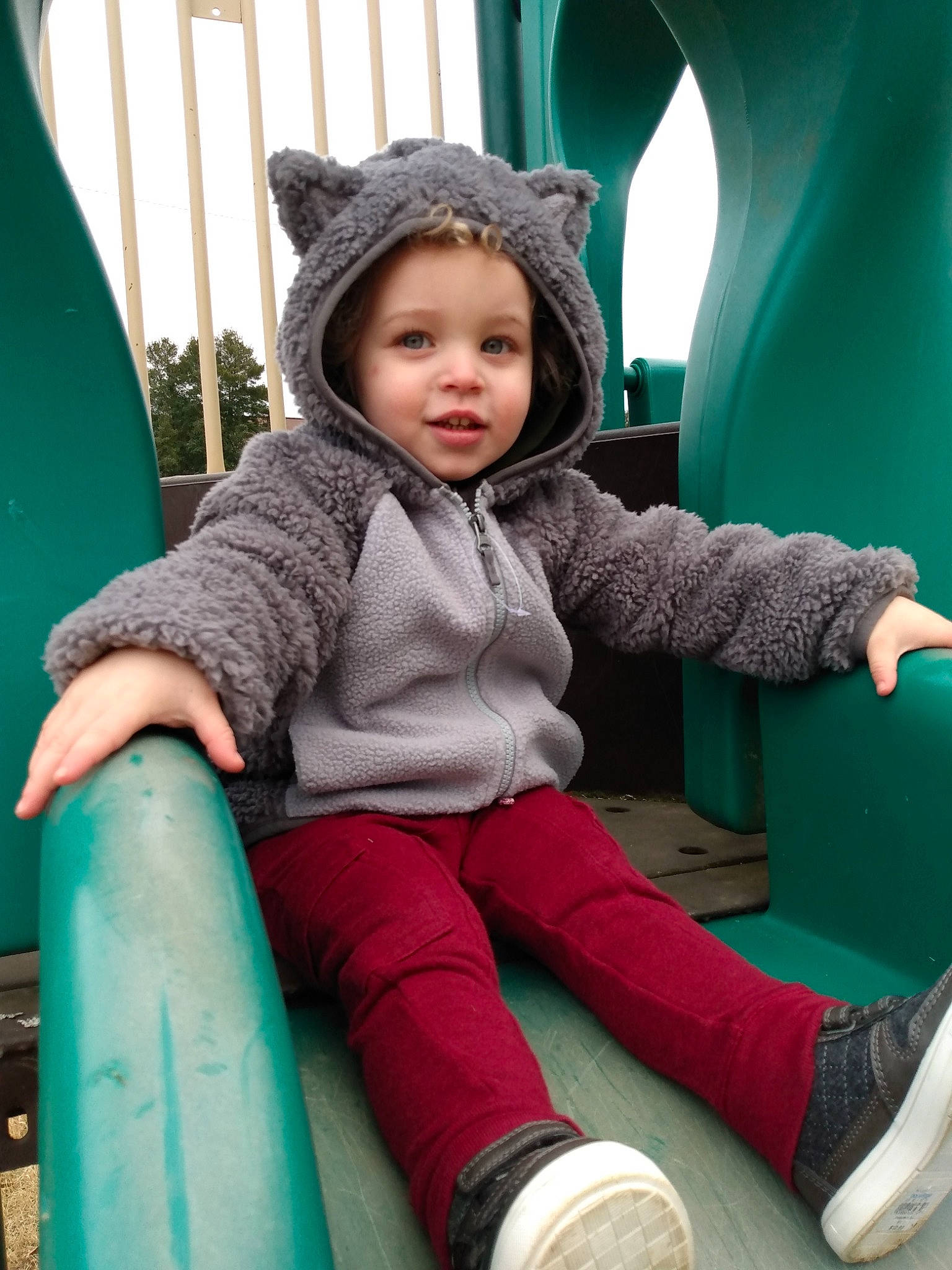 Jared is registered to the contest to win money with this photo: baby_toddler_clothing, blue, cap, child, city, comfort, face, fun, grass, green, happy, headwear, leg, leisure, magenta, person, recreation, sitting, smile, sock