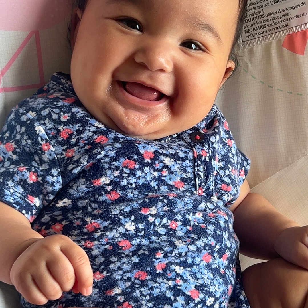 Jadalynn joined the competition — help win amazing prizes! baby, babylaughing, bodypart, clothing, face, finger, furniture, hand, happy, head, laughing, mouth, newborn, person, photography, portrait, sitting, smile, t_shirt, teeth