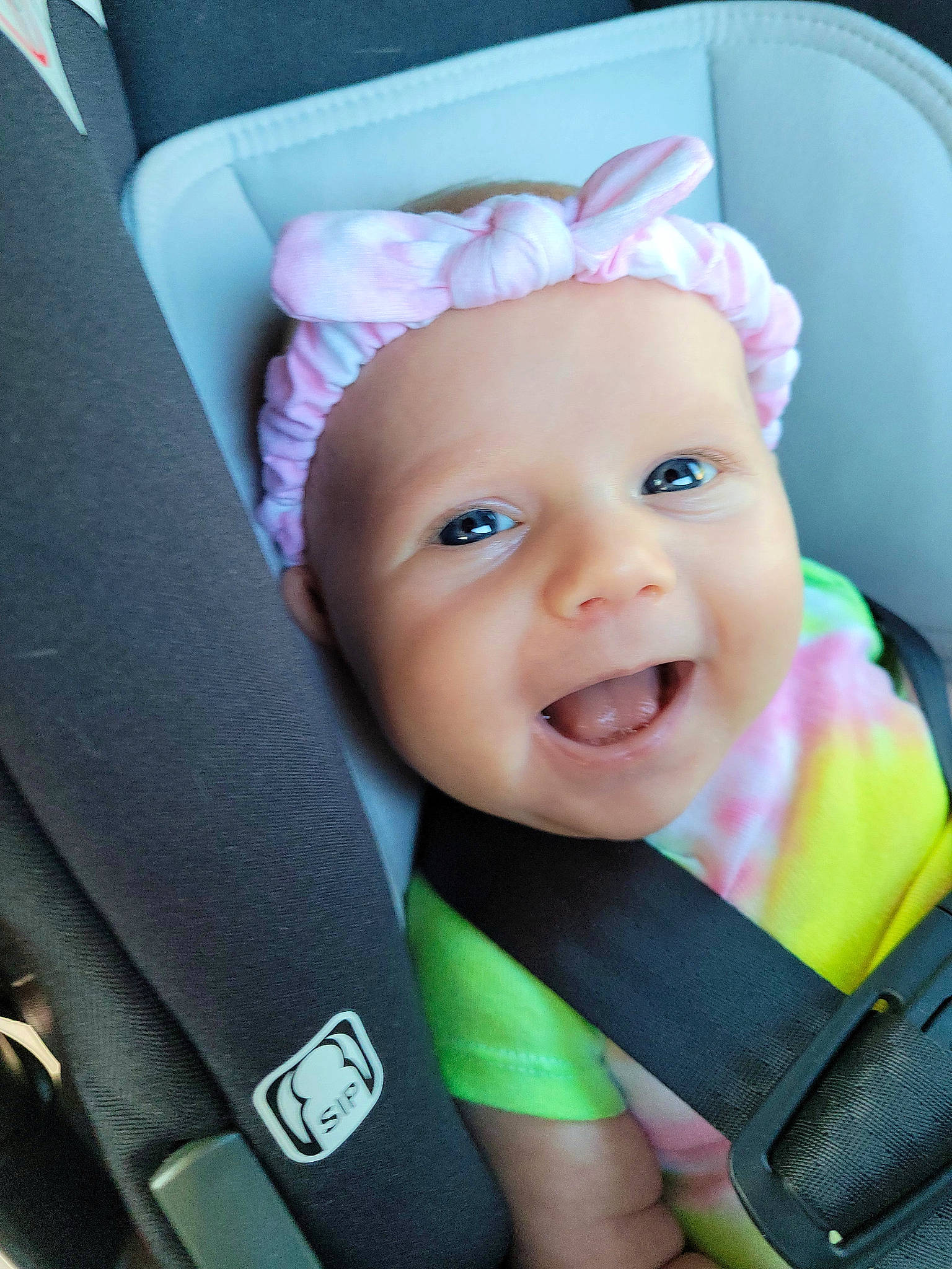Maddie is registered to the contest to win money with this photo: baby, baby_carriage, baby_in_car_seat, baby_toddler_clothing, car_seat, cheek, comfort, eye, eyebrow, face, facial_expression, happy, head, headwear, iris, person, product, seat_belt, skin, smile