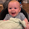 baby, baby_seat, blanket, child, cozy, cute, expression, face, furniture, happy, home, human, indoor, infant, person, portrait, smiling, striped_clothing, toddler, wooden_floor