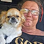 Georgie Pollard is registered to the contest to win money with this photo: woman, dog, glasses, indoor, portrait, pet, small_dog, casual_clothing, smile, shoulder, closeup, human, animal, face, hair, relaxed, seated, text_on_clothing, vehicle_interior, companion