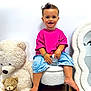 toddler, child, smiling, pink_shirt, denim_shorts, barefoot, stuffed_teddy_bear, plush_toy, white_wall, mirror, chair, carpet, indoor, cute, happy, portrait, sitting, toy, cozy, home_decor