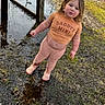 toddler, child, muddy, puddle, outdoor, grass, shirt, clothing, shoes, mud, face, person, standing, nature, playful, messy, casual, expression, daylight, young