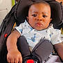 baby, car_seat, child, infant, seatbelt, bus, public_transport, people, hand, clothing, expression, serious, person, indoor, sitting, shoulder, shorts, shirt, black_hair, skin