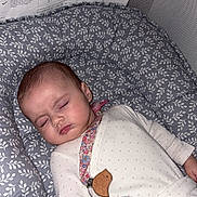 Lyana a rejoint le concours — aidez-le/la à gagner de superbes lots ! baby, sleeping, onesie, blanket, pacifier_clip, cushion, floral_pattern, infant, child, resting, indoors, peaceful, cute, soft_texture, head, face, hand, nap, comfort, cozy