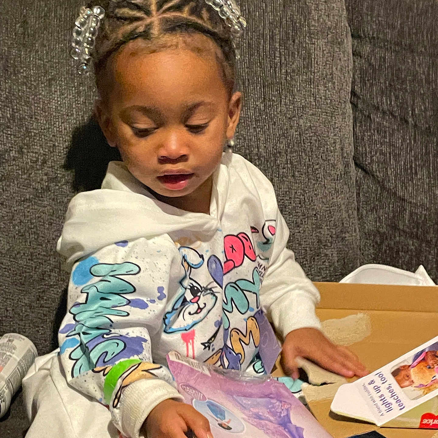 Kehlani joined the competition — help win amazing prizes! animal, bird, blackhair, braid, child, clothing, couch, cushion, face, female, furniture, girl, hair, head, homedecor, openingpresent, person, reading, sitting, student