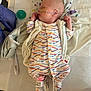 baby, newborn, hospital, medical_tube, pacifier, blanket, sleeping, infant, onesie, bed, healthcare, person, cute, child, resting, wearing_clothes, indoors, soft, tender, peaceful