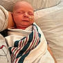 newborn, baby, infant, hospital, blanket, feeding_tube, sleeping, swaddled, person, bed, rest, healthcare, care, adult_arm, comfort, soft, closeup, indoors, peaceful, wrapped