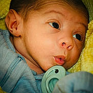 Josiah joined the competition — help win amazing prizes! baby, newborn, infant, pacifier, blanket, yellow_blanket, swaddle, onesie, close_up, face, eye, mouth, ear, cheek, drool, portrait, sleepwear, soft_texture, cute, human