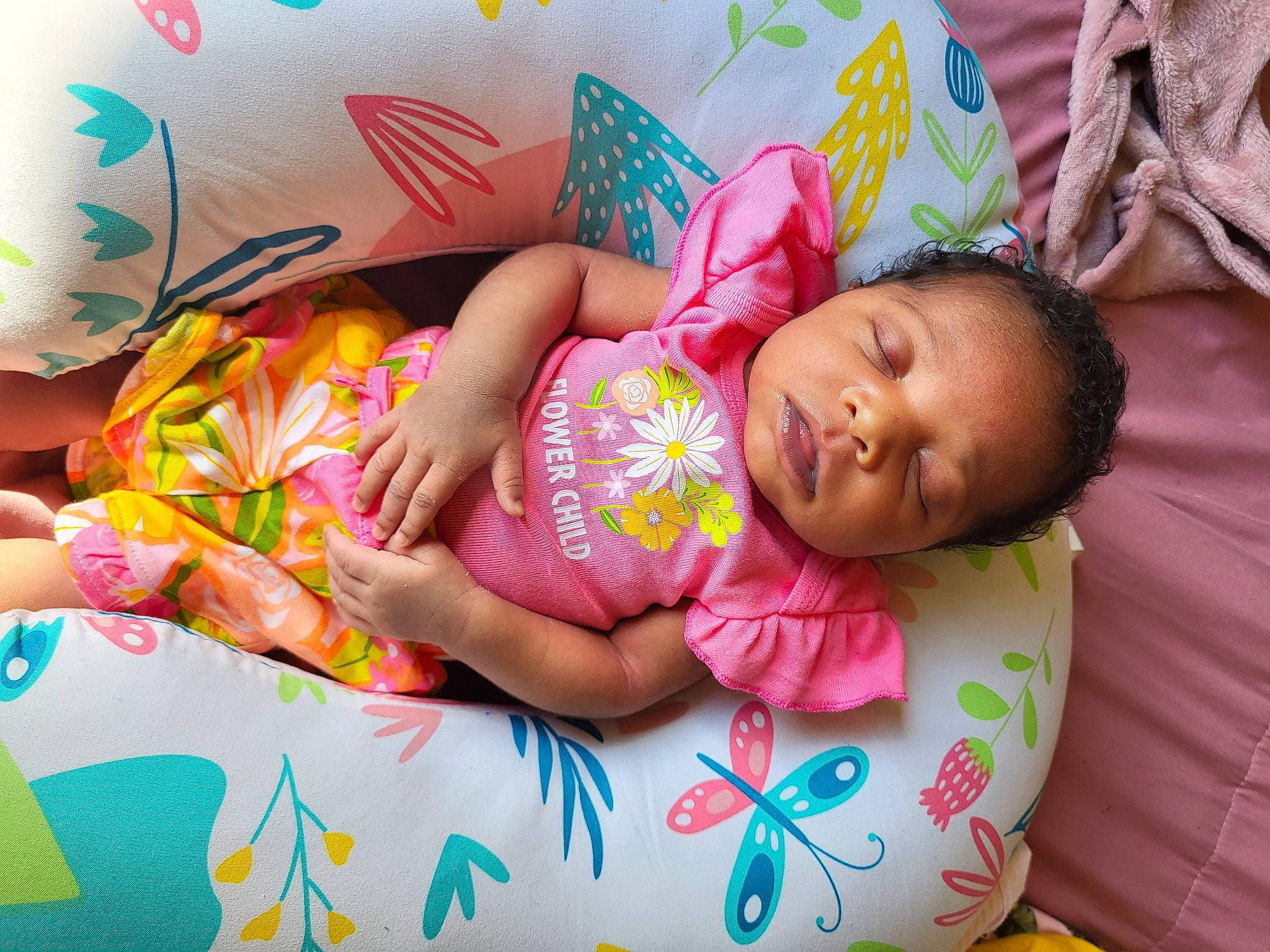 Iyanna is registered to the contest to win money with this photo: baby, baby_products, baby_toddler_clothing, bedtime, cheek, child, comfort, facial_expression, fun, hand, happy, head, human, linens, person, pink, room, skin, textile, toddler