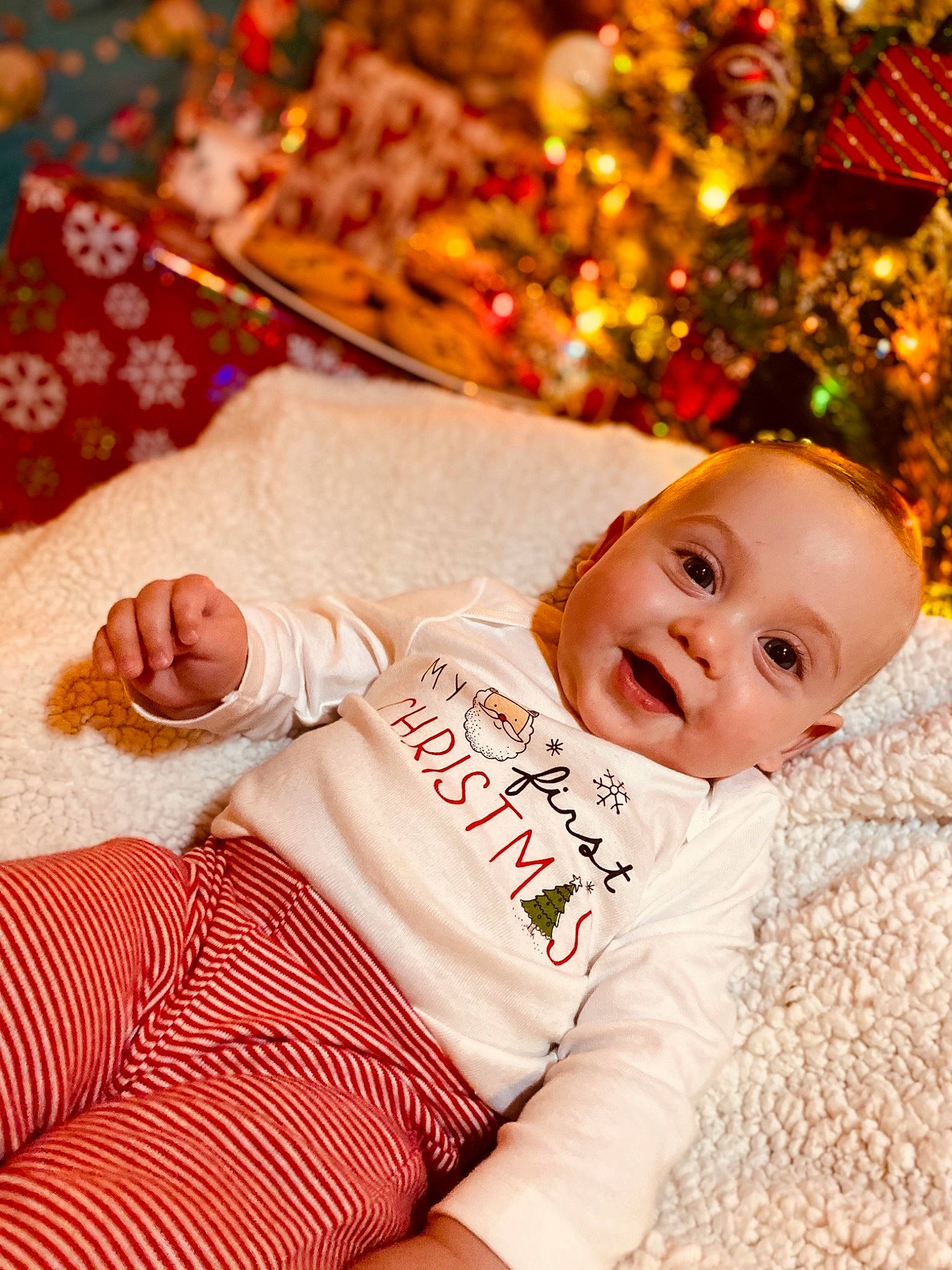 Leighton is registered to the contest to win money with this photo: baby, cheek, child, christmas, christmas_eve, happy, holiday, person, smile, toddler, tree