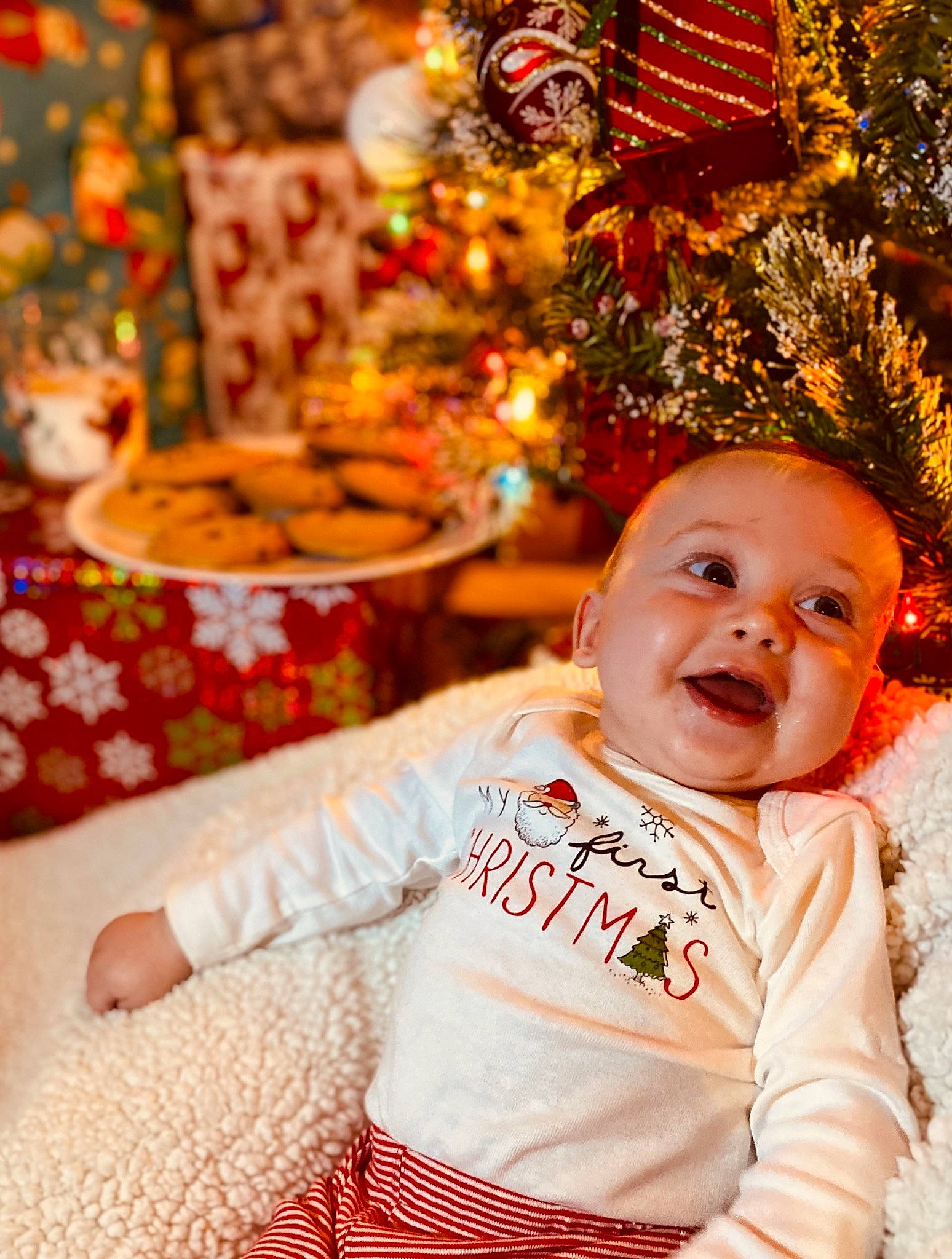 Leighton is registered to the contest to win money with this photo: baby, child, christmas, christmas_decoration, christmas_eve, christmas_ornament, christmas_tree, event, happy, holiday, interior_design, person, smile, toddler, tradition, tree, yellow