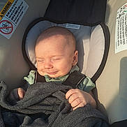 Julian joined the competition — help win amazing prizes! baby, car_seat, blanket, child, smiling, sleepy, sunlight, infant, clothing, seatbelt, comfort, cute, relaxed, indoors, head, hand, face, soft_texture, resting, peaceful