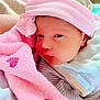 Inaya participe au concours pour gagner de l'argent avec cette photo : baby, newborn, pink_headband, blanket, towel, heart_pattern, face, infant, cute, soft_texture, cozy, sleepy, clothing, person, portrait, indoor, closeup, headwear, resting, wrapped