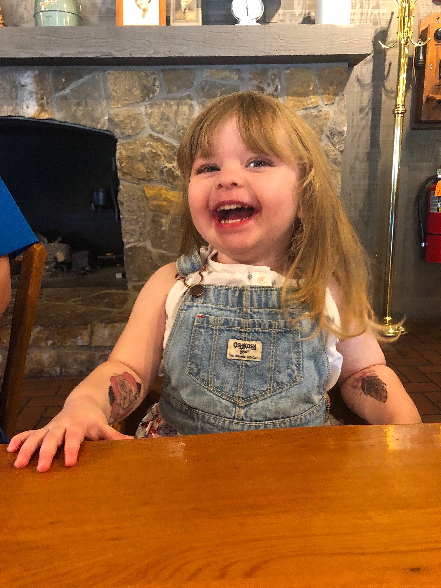 Abby joined the competition — help win amazing prizes! blond, child, facial_expression, finger, floor, flooring, fun, hand, hardwood, person, play, sitting, smile, table, toddler, vacation, wood