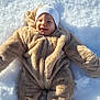 baby, infant, child, snow, winter, snowsuit, hat, smile, outdoors, cold, cozy, cute, cheeks, lying_down, playful, sunlight, texture, footprint, plush, portrait