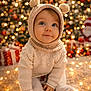 baby, blue_eyes, blurred_background, child, christmas_tree, cozy, cute, fairy_lights, festive, holiday, indoor, knit_hat, knit_sweater, pom_poms, portrait, presents, seasonal, smile, soft_texture, warm_lighting