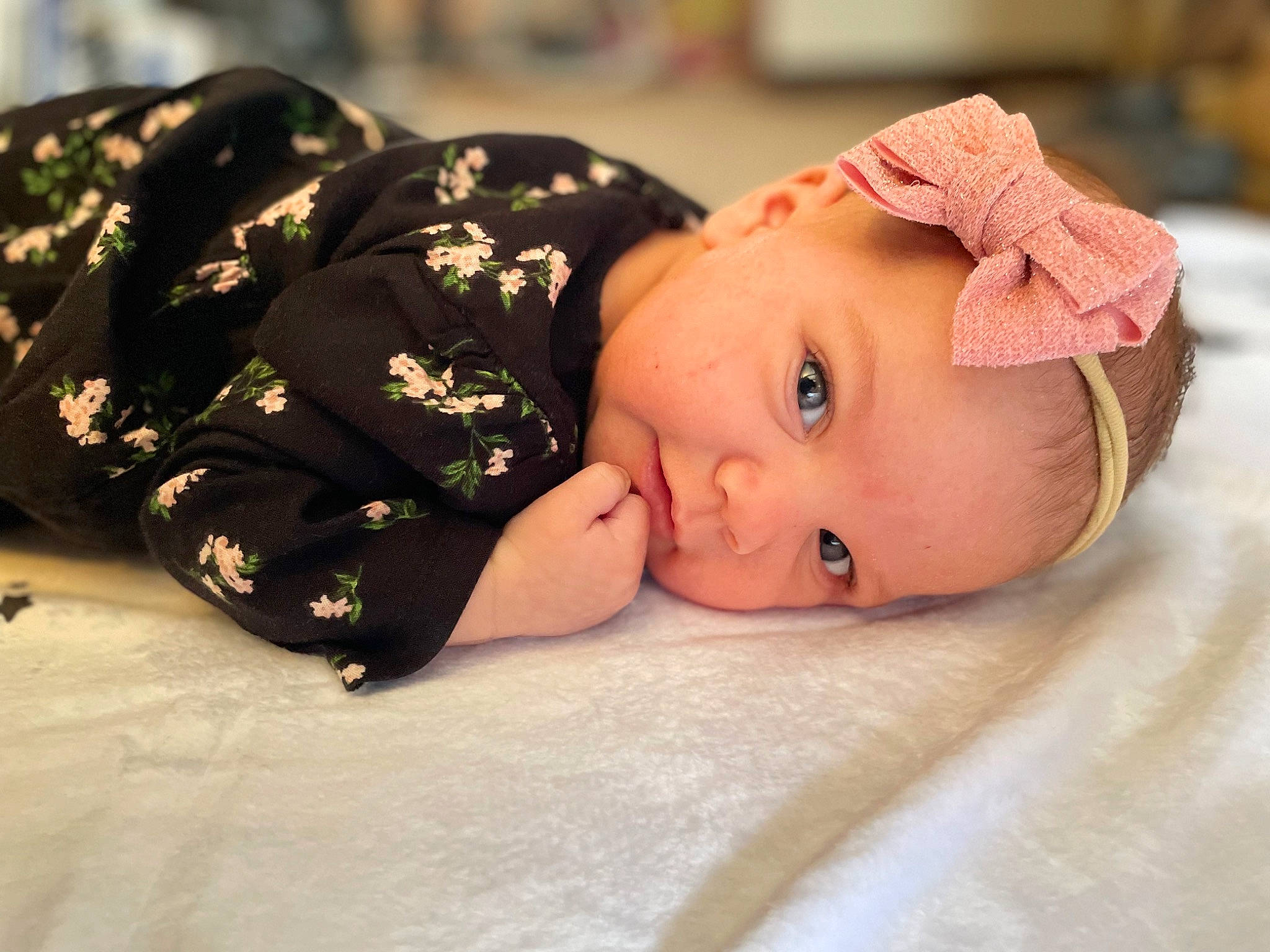 Clementine is registered to the contest to win money with this photo: baby, baby_toddler_clothing, cheek, child, comfort, eye, eyebrow, fashion_accessory, flooring, hair_accessory, happy, hat, lip, pattern, person, portrait_photography, sitting, skin, sleeve, toddler