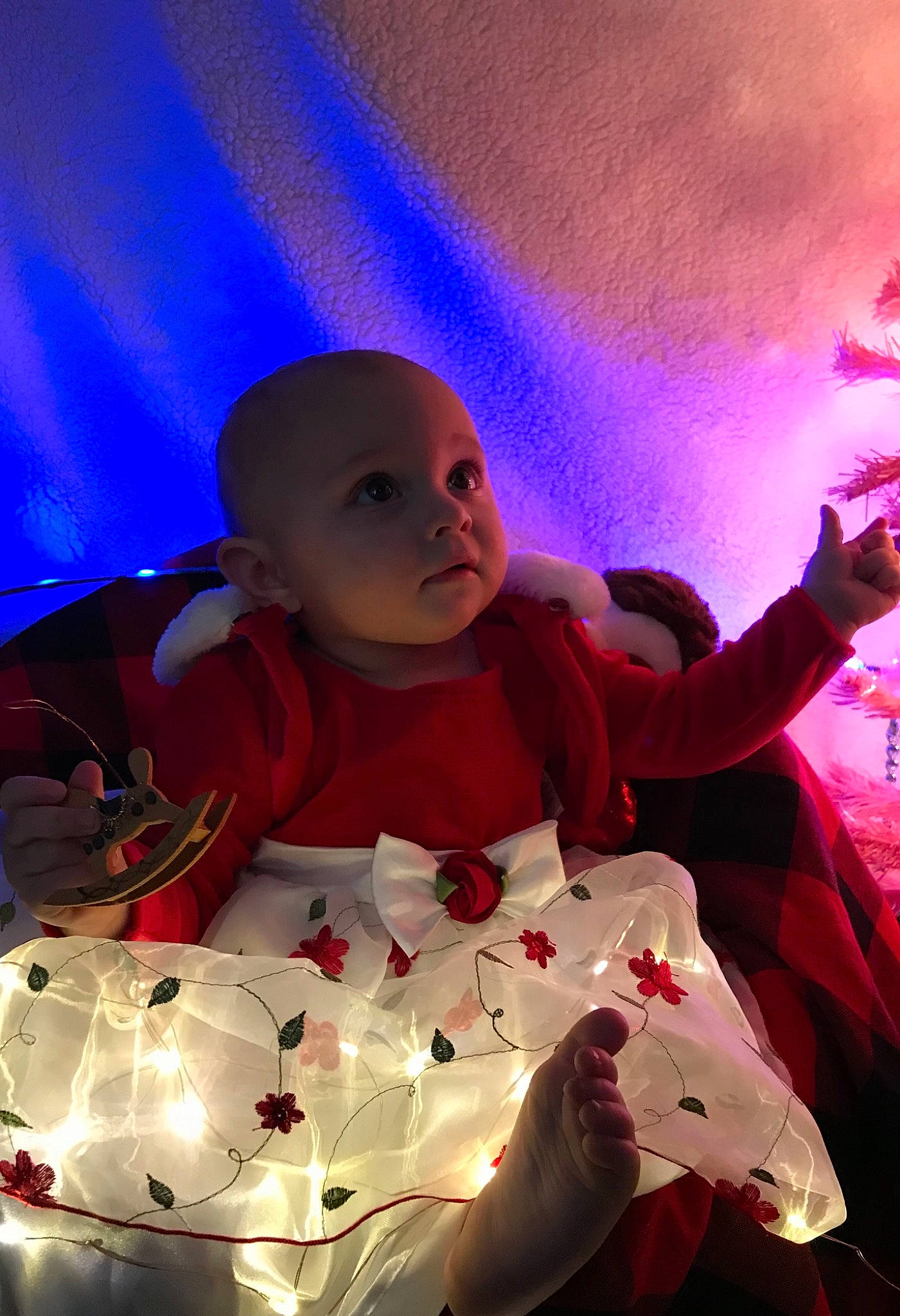 Marley is registered to the contest to win money with this photo: baby, baby_toddler_clothing, christmas_eve, entertainment, event, fictional_character, flash_photography, fun, happy, hat, holiday, human_body, lighting, magenta, person, pink, plant, purple, toddler, tree